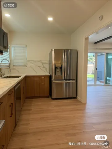 a kitchen with stainless steel appliances granite countertop a refrigerator and a sink