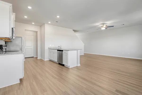 a kitchen with stainless steel appliances granite countertop a stove a sink and a refrigerator
