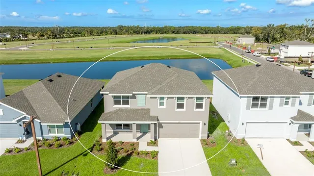 an aerial view of a house with a swimming pool and outdoor space