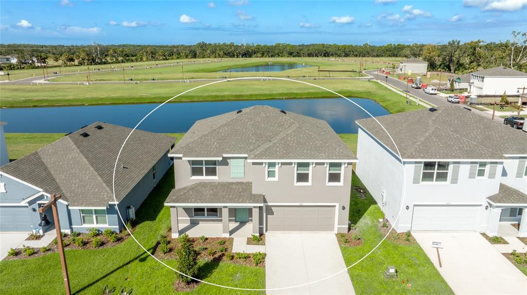 an aerial view of a house with a swimming pool and outdoor space