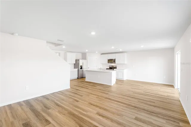 a view of kitchen living room with wooden floor