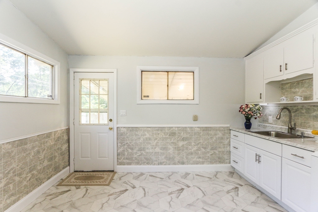 31 Fieldston Street Springfield, MA 01119 - Photo 14 of 32 a spacious bathroom with a granite countertop sink a mirror and a