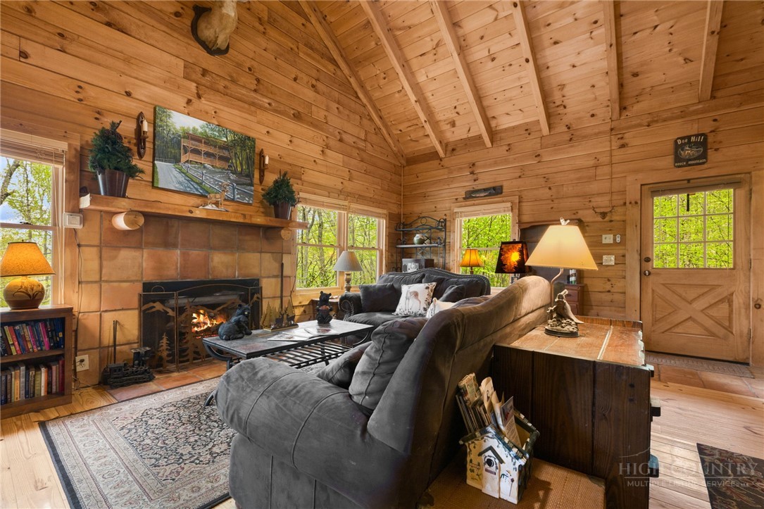 259 Greenbriar Road Beech Mountain, NC 28604 - Photo 12 of 41 a living room with furniture and a fireplace
