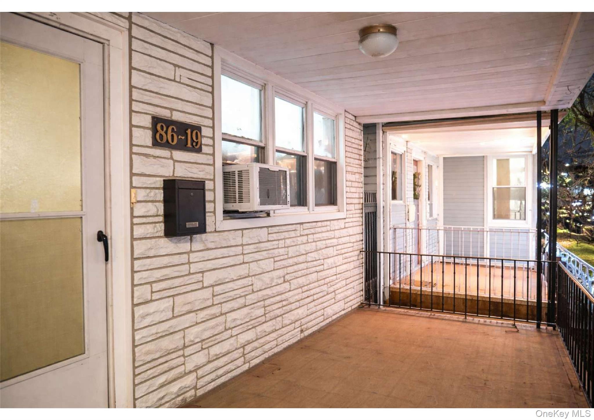 86-19 79th Street Queens, NY 11421 - Photo 11 of 19 a view of a hallway with windows
