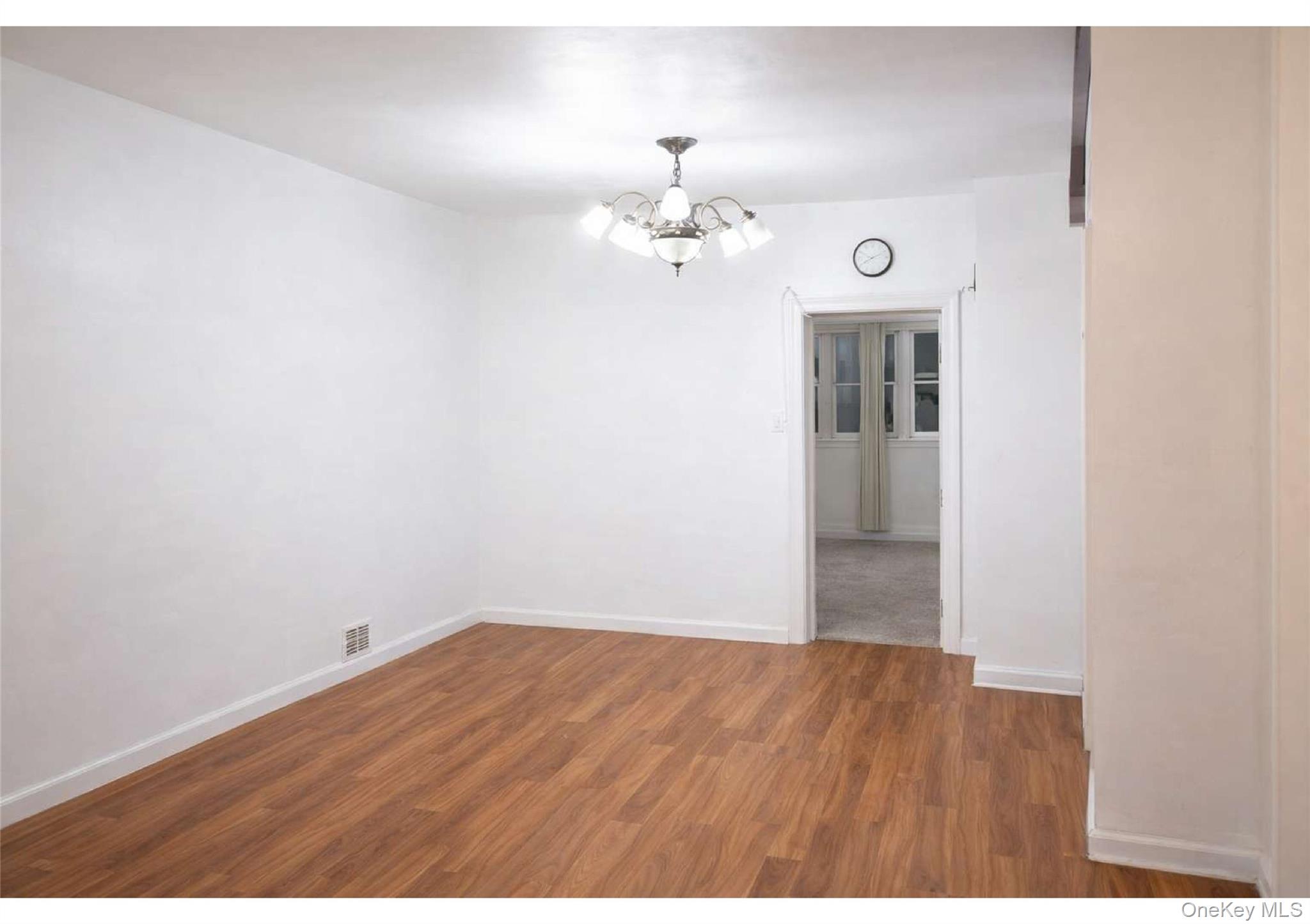 86-19 79th Street Queens, NY 11421 - Photo 14 of 19 a view of a room with wooden floor