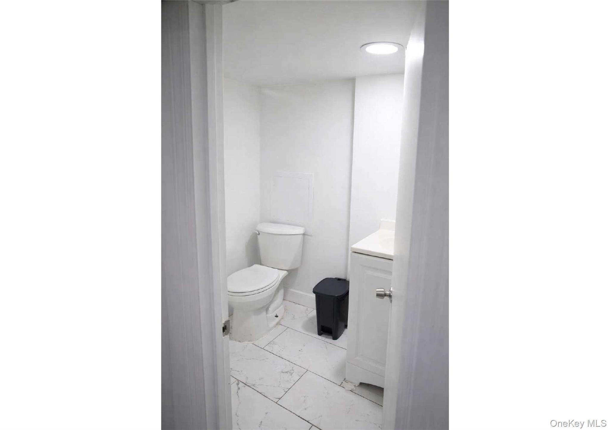 86-19 79th Street Queens, NY 11421 - Photo 16 of 19 a bathroom with a toilet and a sink