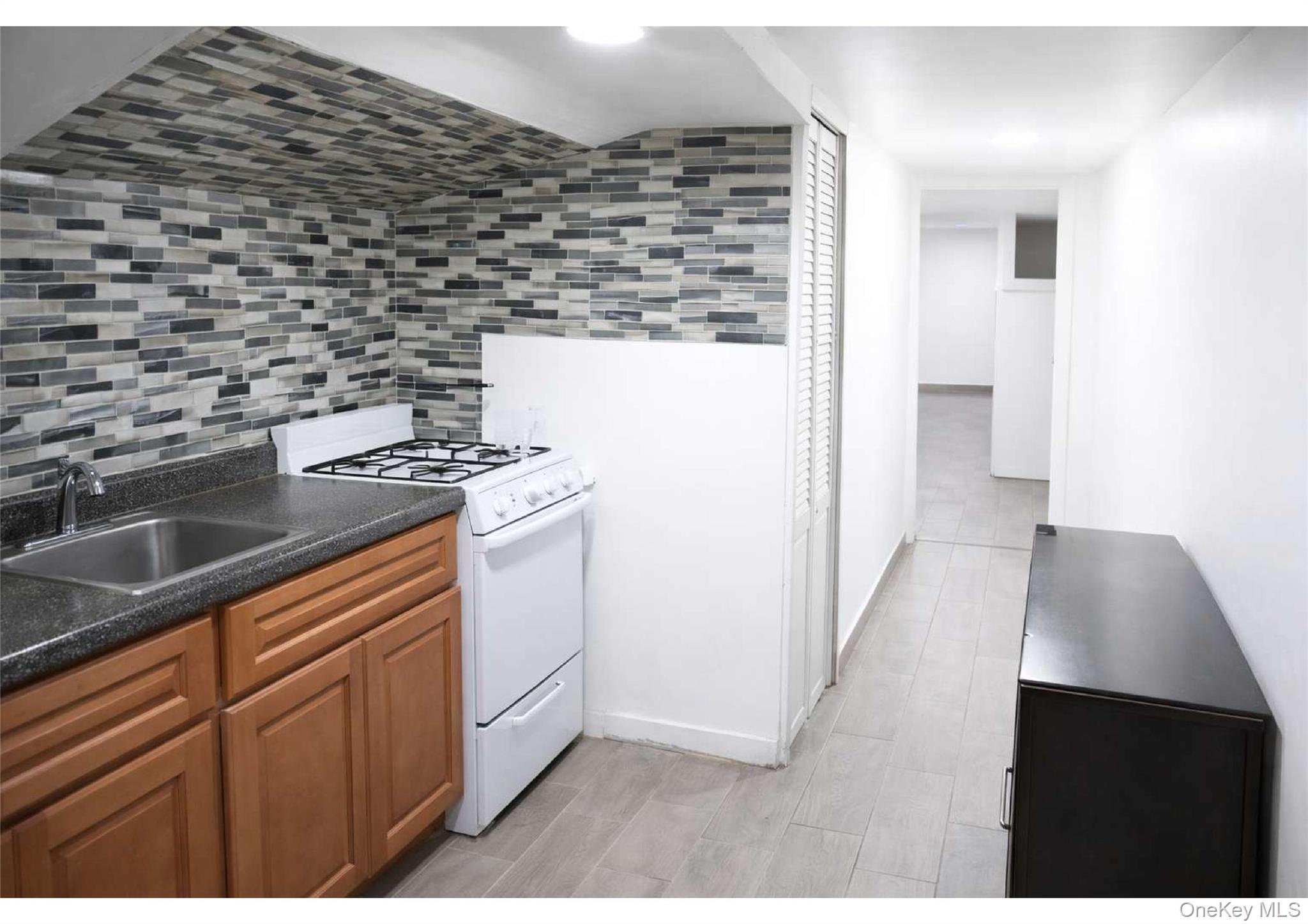 86-19 79th Street Queens, NY 11421 - Photo 4 of 19 a kitchen with a stove and a cabinets