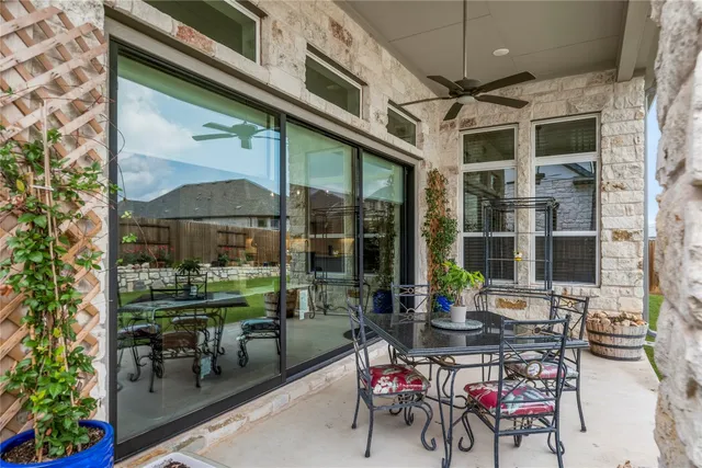 a view of a chairs and table in the balcony