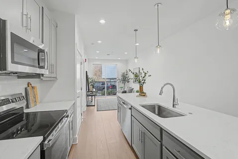 a kitchen with a sink a counter space and appliances