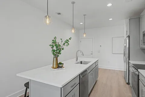 a kitchen with a sink stove and refrigerator