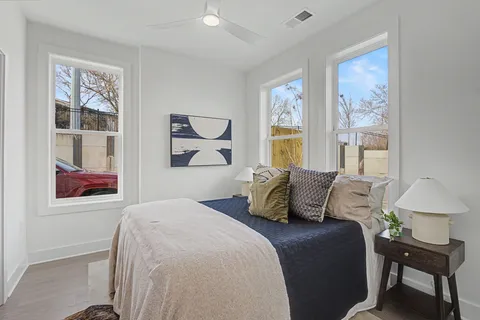 a bedroom with a bed and a large window