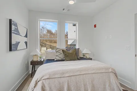 a bedroom with a bed and a window