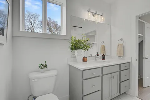 a bathroom with a double vanity sink a mirror and a bathtub