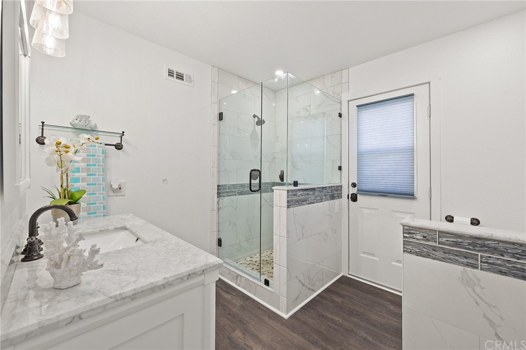 394 Tolbert Street Brea, CA 92823 - Photo 12 of 21 a bathroom with a granite countertop sink a mirror and shower