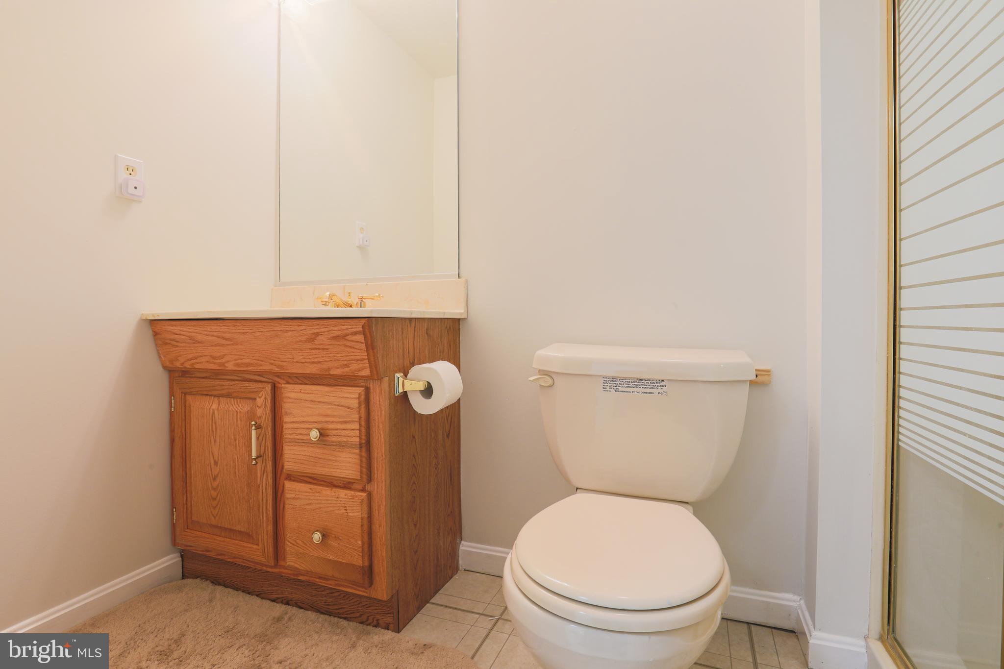 9547 Hallhurst Road Baltimore, MD 21236 - Photo 28 of 49 a white toilet sitting next to a sink
