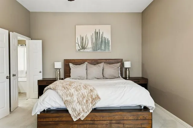 a bedroom with a bed and a painting on the wall