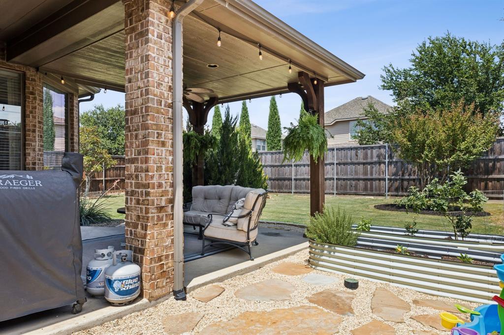910 Fox Ridge Trail Prosper, TX 75078 - Photo 20 of 25 a view of a patio with a table and chairs and potted plants