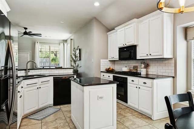 a kitchen with stainless steel appliances granite countertop a sink stove and microwave