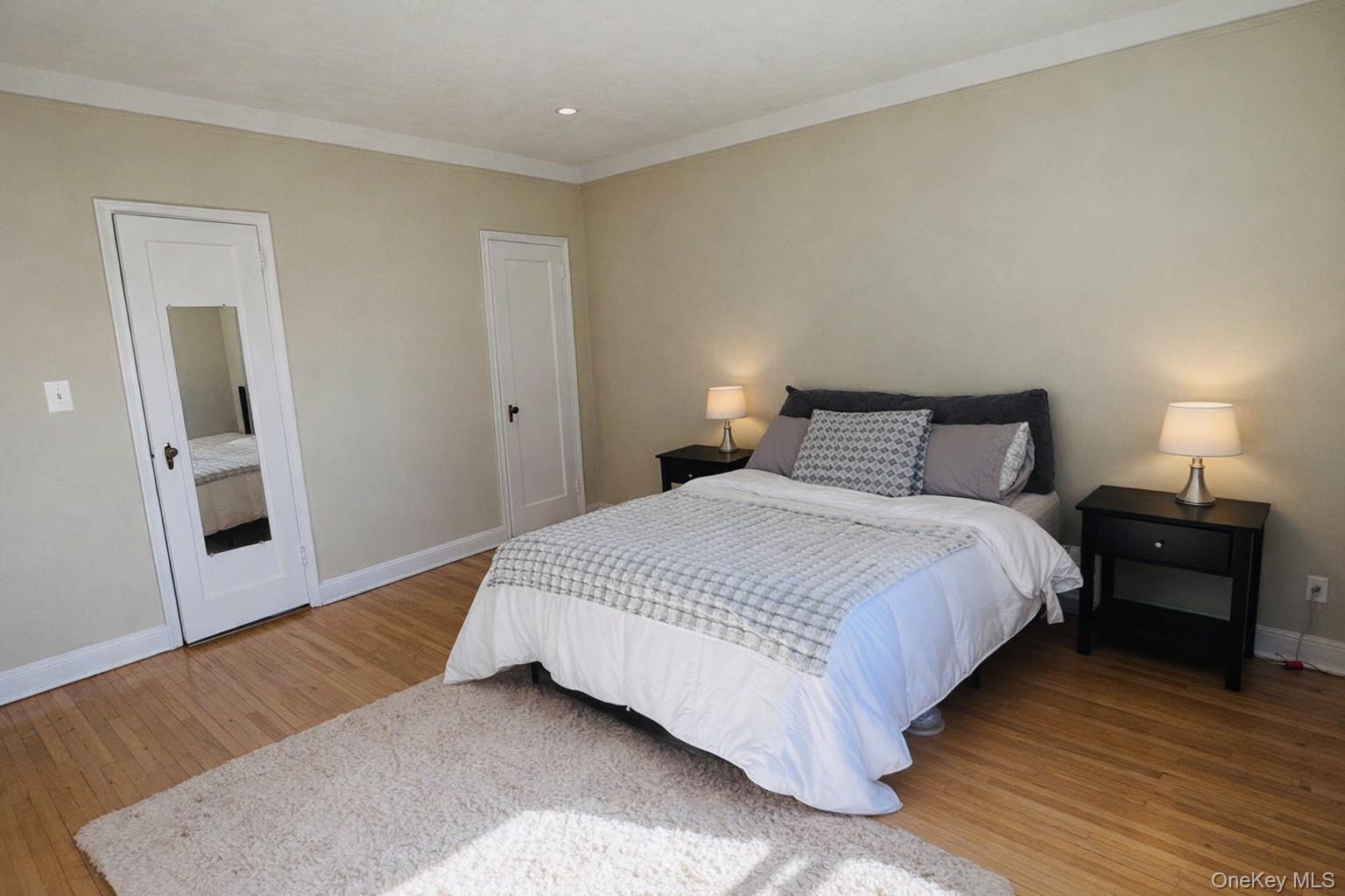 110-35 72nd Road, Unit 503 Queens, NY 11375 - Photo 11 of 15 a bedroom with a bed and wooden floor