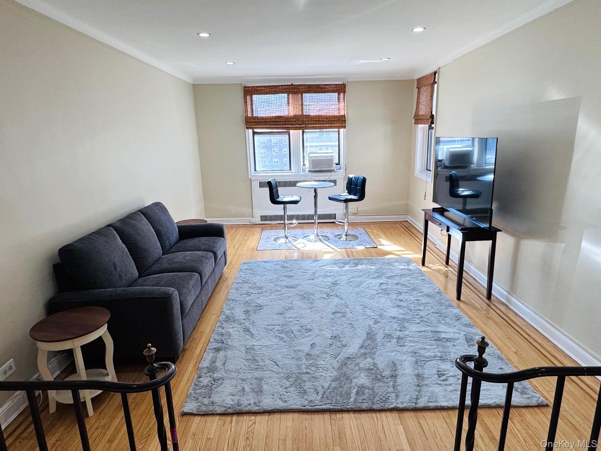 110-35 72nd Road, Unit 503 Queens, NY 11375 - Photo 3 of 15 a living room with furniture and wooden floor