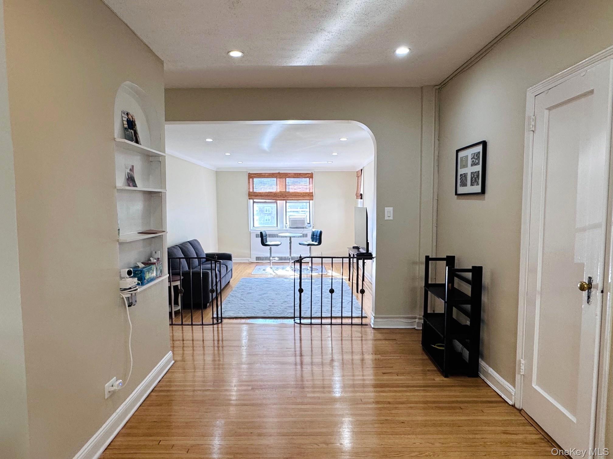 110-35 72nd Road, Unit 503 Queens, NY 11375 - Photo 5 of 15 a living room with furniture and a wooden floor