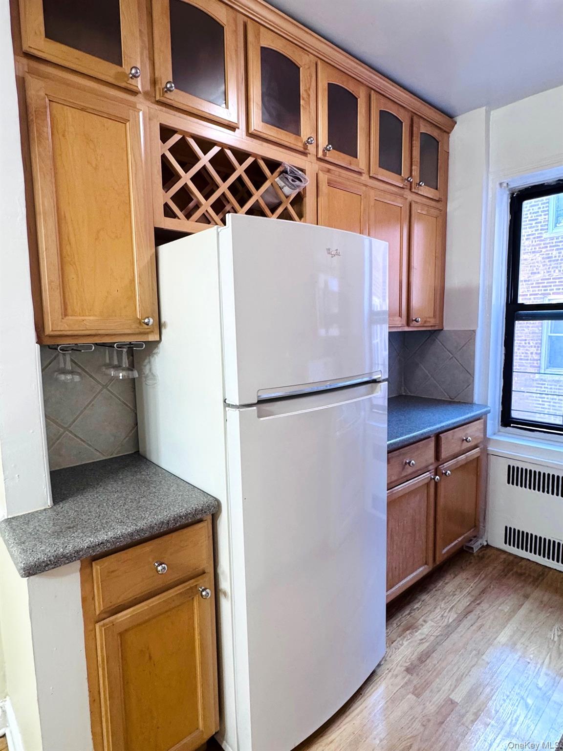 110-35 72nd Road, Unit 503 Queens, NY 11375 - Photo 8 of 15 a kitchen with stainless steel appliances granite countertop a refrigerator and a stove