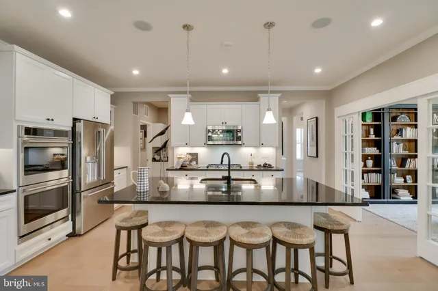 a large kitchen with a table and chairs