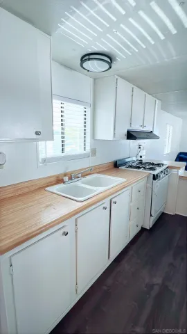 a kitchen with a sink cabinets and window