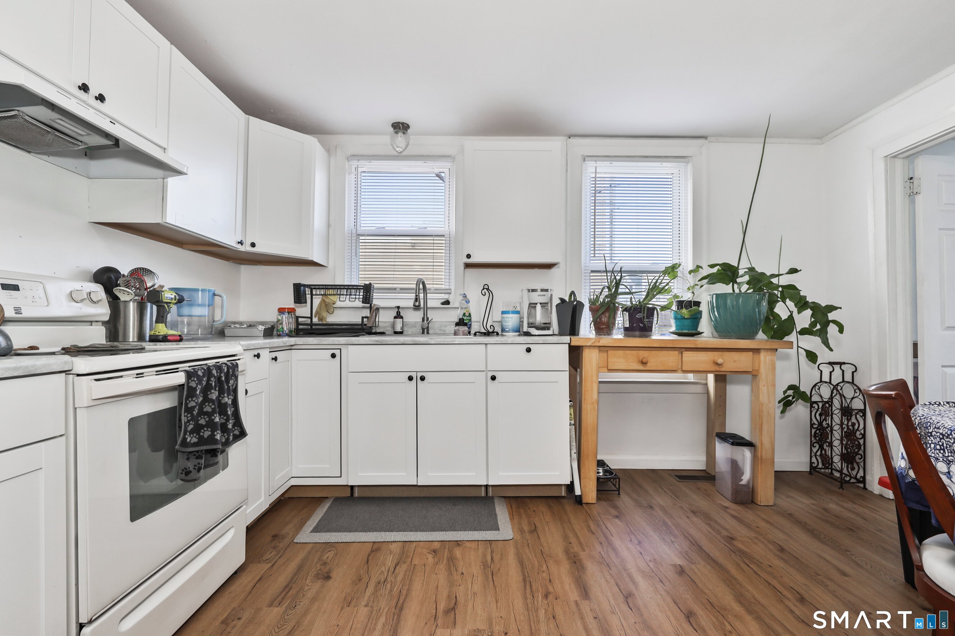 a kitchen with sink cabinets and wooden floor