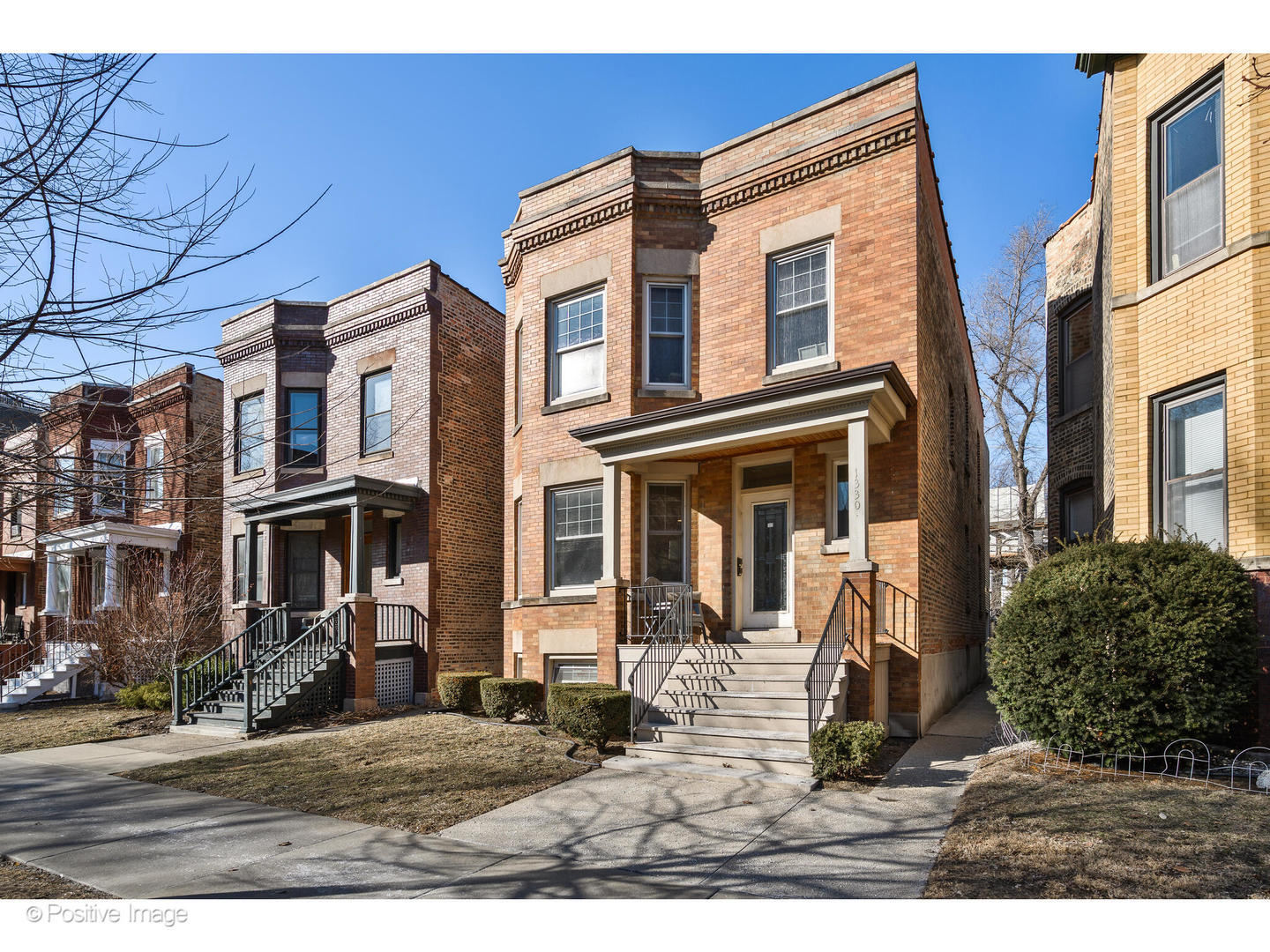 a view of a brick house with many windows