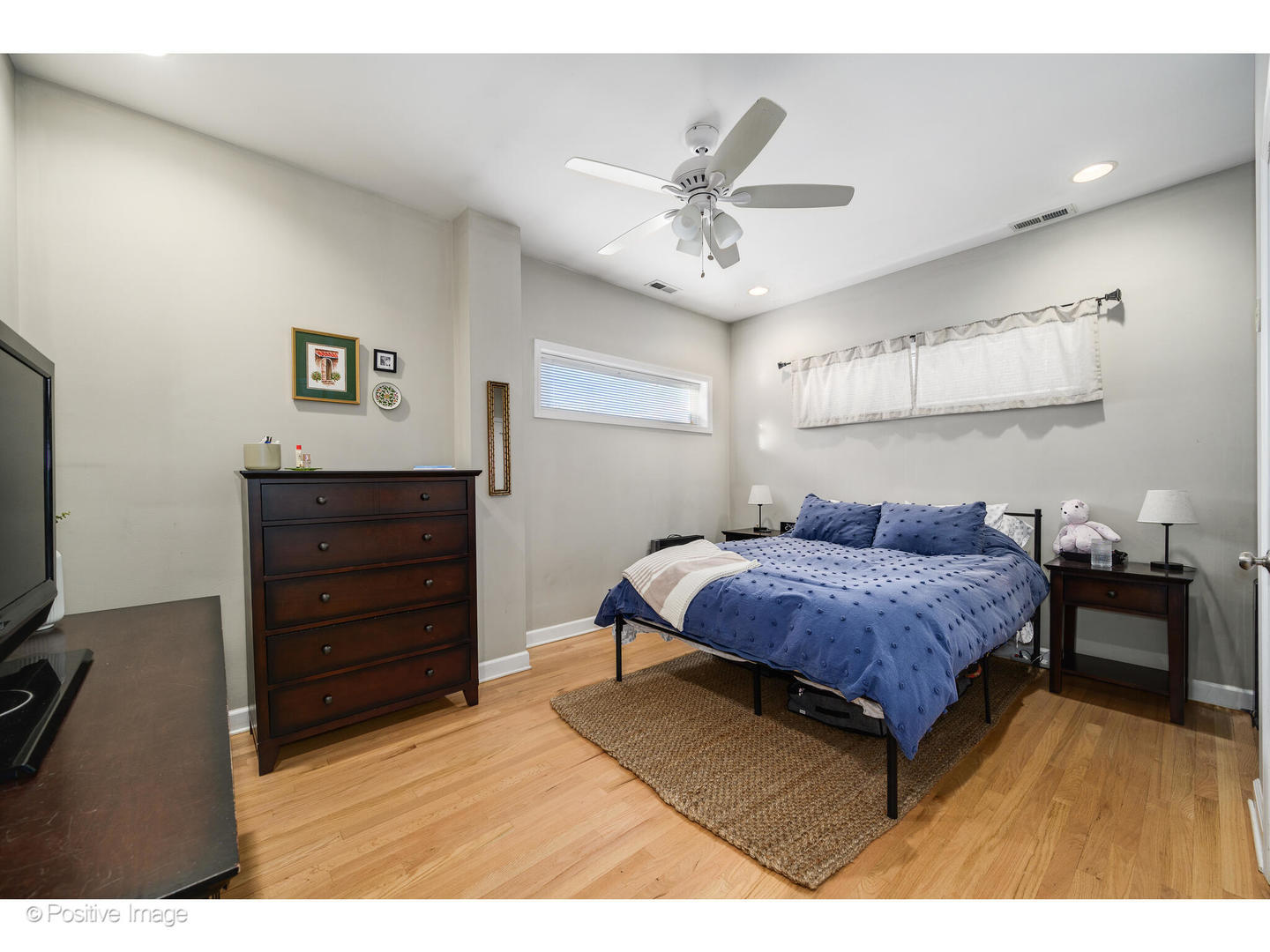 1330 West Roscoe Street Chicago, IL 60657 - Photo 11 of 26 a bedroom with a bed and a flat tv screen on dresser