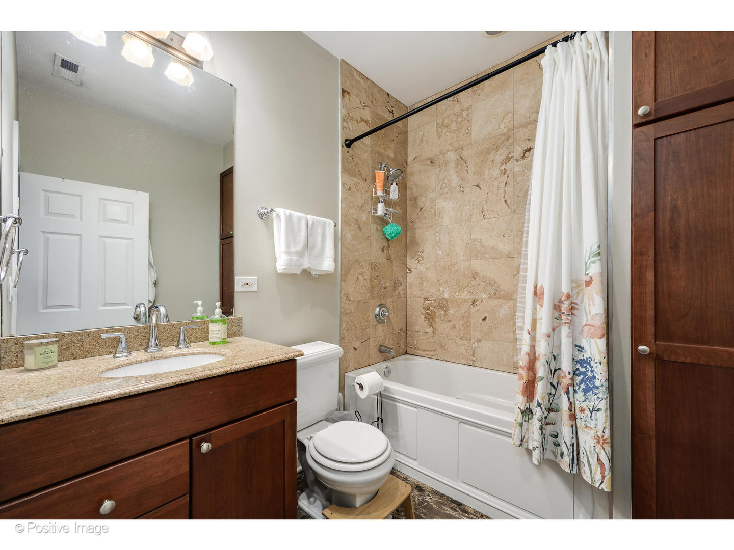 1330 West Roscoe Street Chicago, IL 60657 - Photo 12 of 26 a bathroom with a sink a toilet a mirror a bathtub and shower