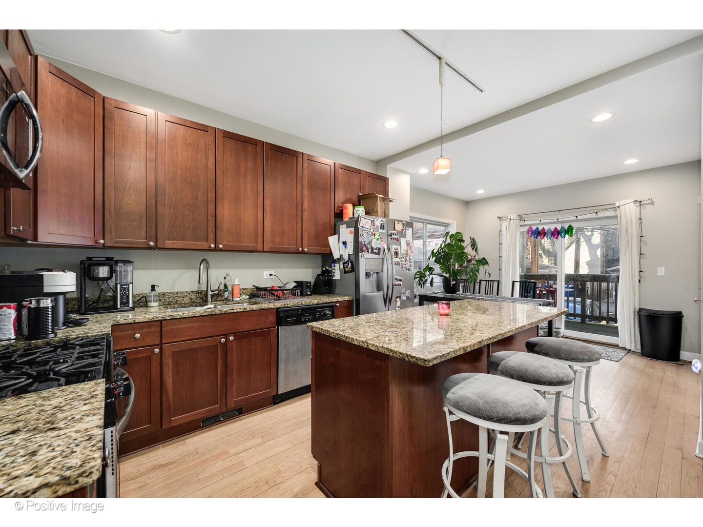 1330 West Roscoe Street Chicago, IL 60657 - Photo 15 of 26 a kitchen with granite countertop a table chairs stove and cabinets