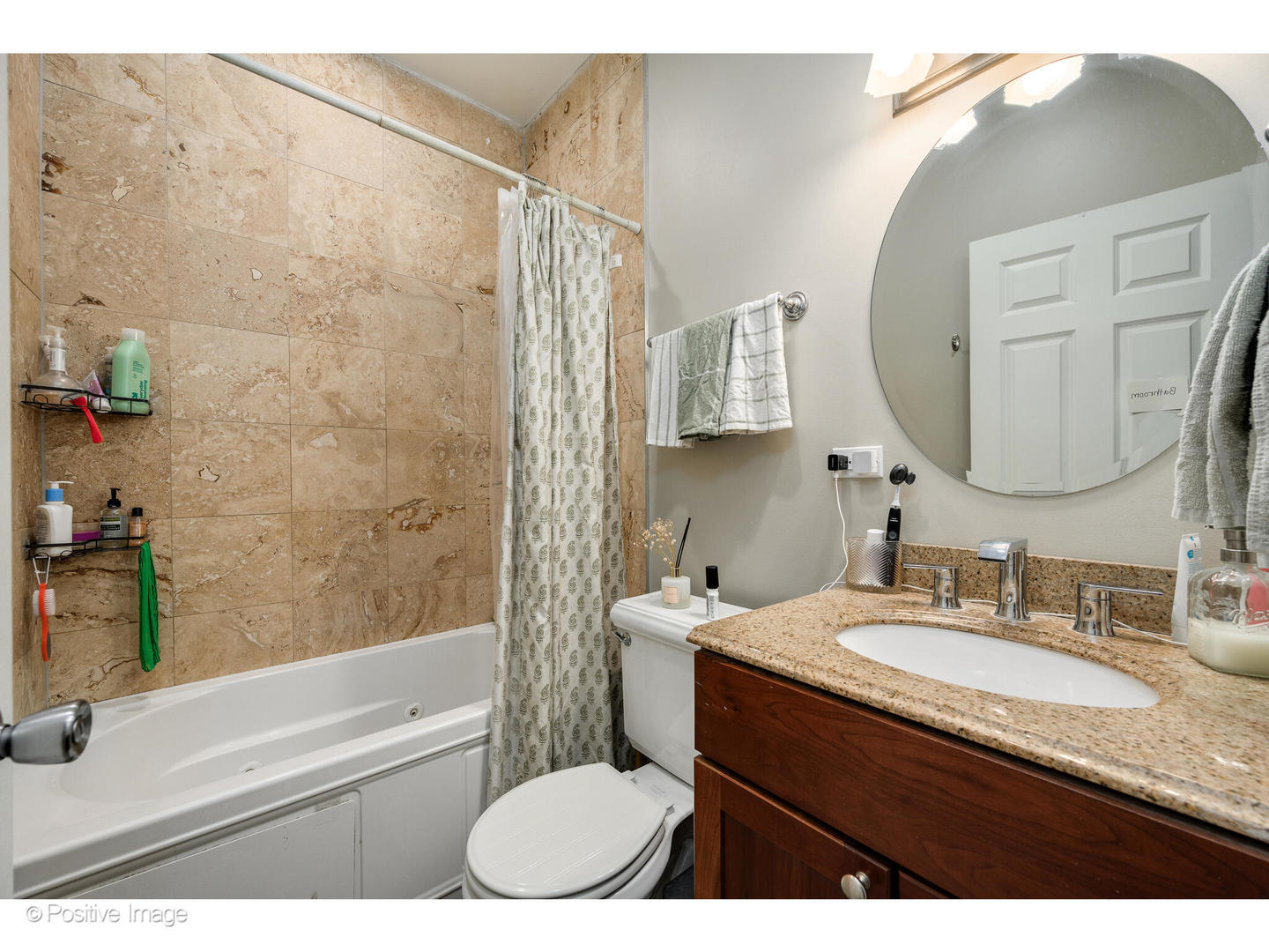 1330 West Roscoe Street Chicago, IL 60657 - Photo 18 of 26 a bathroom with a granite countertop sink mirror toilet and bathtub