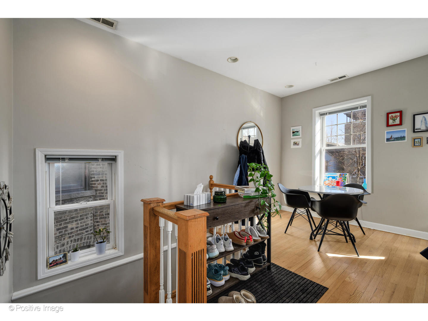 1330 West Roscoe Street Chicago, IL 60657 - Photo 2 of 26 a living room with furniture a desk and chair with potted plants