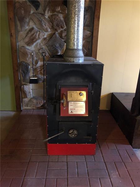 354 Strawcutter Road Derry, PA 15627 - Photo 9 of 22 Wood burner in Basement connected as Aux heat