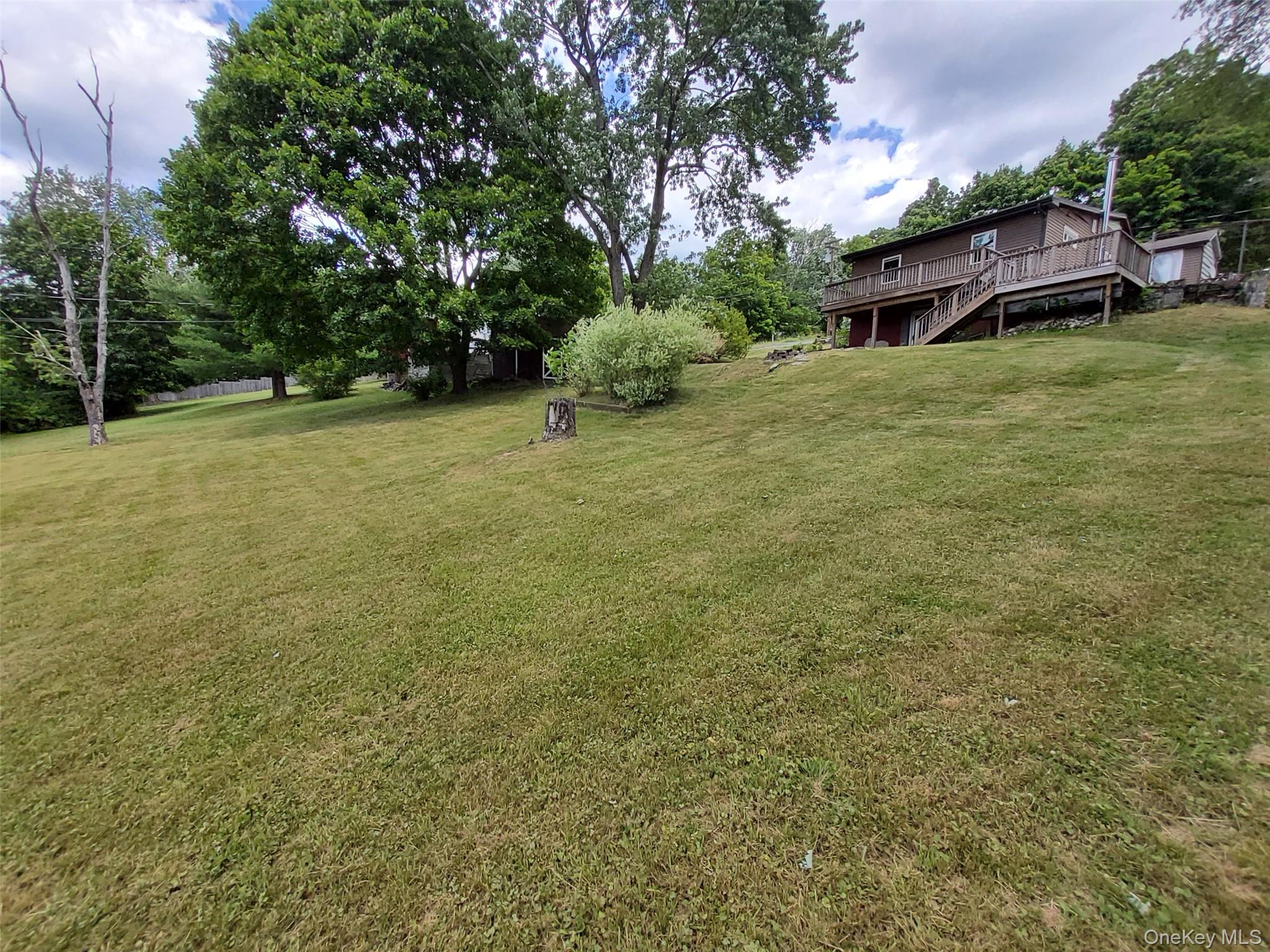 469 Hillside Road Monroe, NY 10950 - Photo 18 of 20 a yellow house sitting in middle of the yard