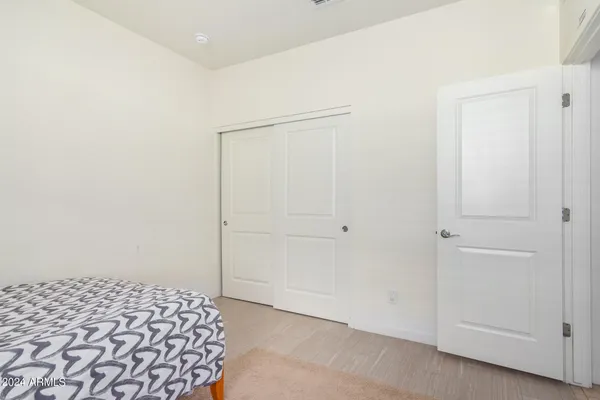 a bedroom with a bed and a lamp
