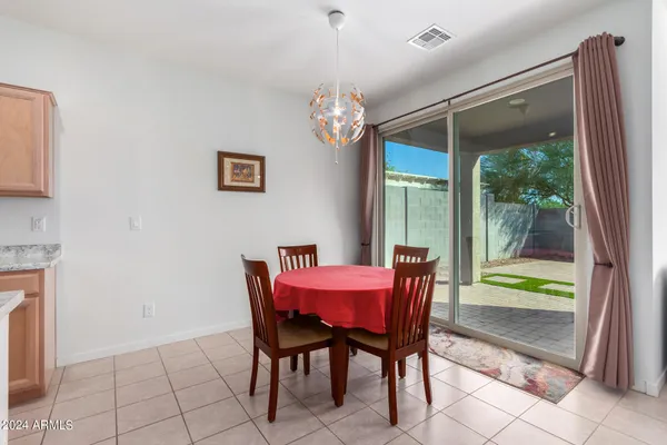 a dining room with furniture a chandelier and a rug