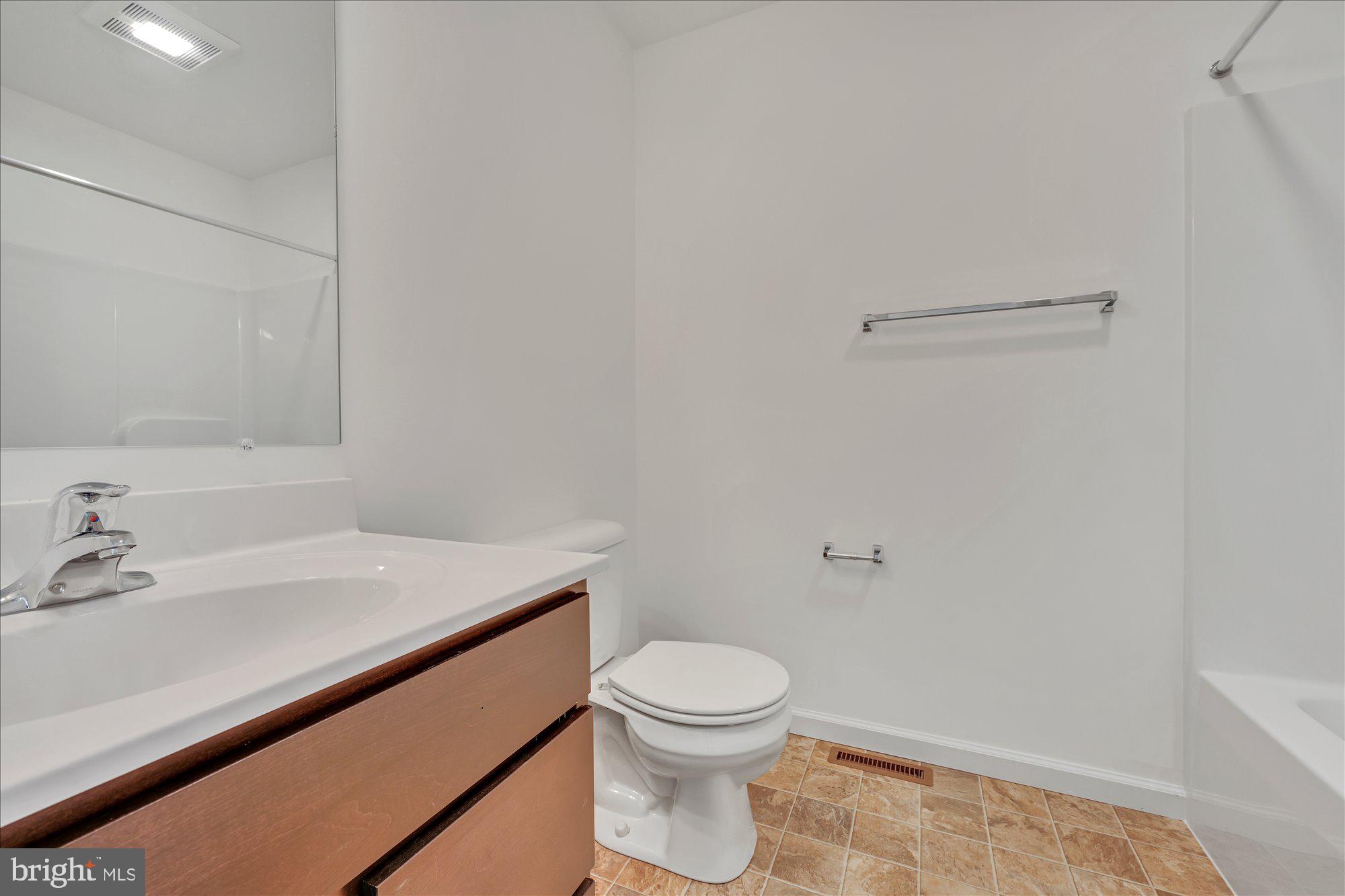 24 Meadow Lane, Unit 18 Hanover, PA 17331 - Photo 11 of 21 a bathroom with a sink a toilet and a mirror