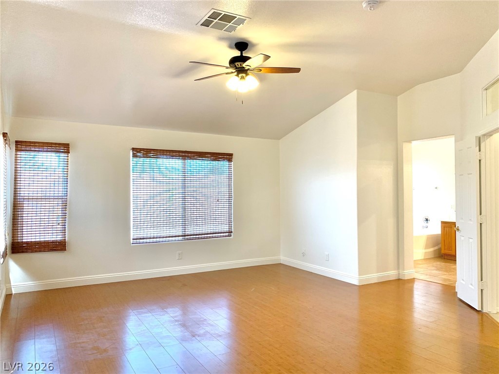 3821 Bombastic Court Las Vegas, NV 89147 - Photo 25 of 36 This airy room features durable wood flooring, creating a warm and inviting atmosphere.