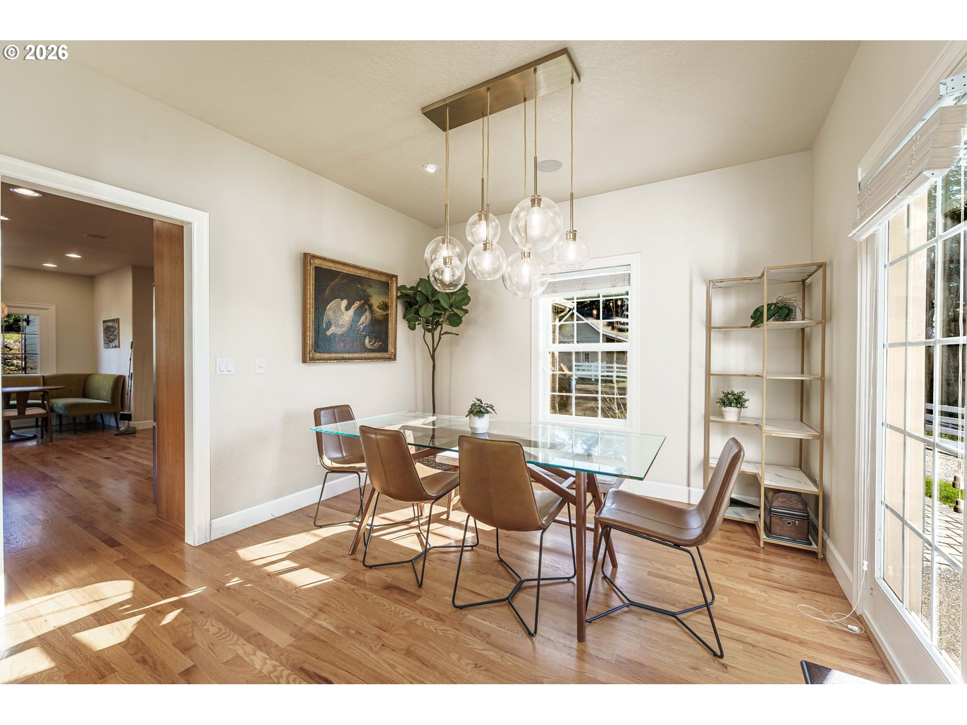 19121 Northwest 61st Avenue Ridgefield, WA 98642 - Photo 12 of 39 a view of a dining room with furniture and a chandelier