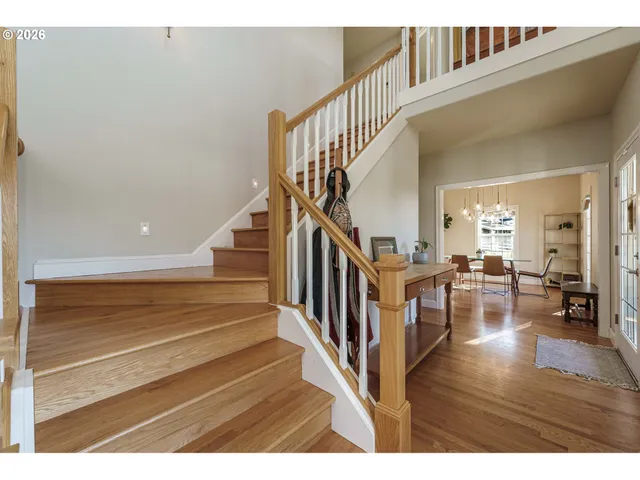 a view of entryway and hall with wooden floor
