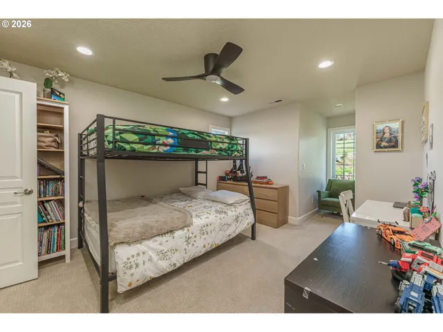 a bedroom with furniture and a large window