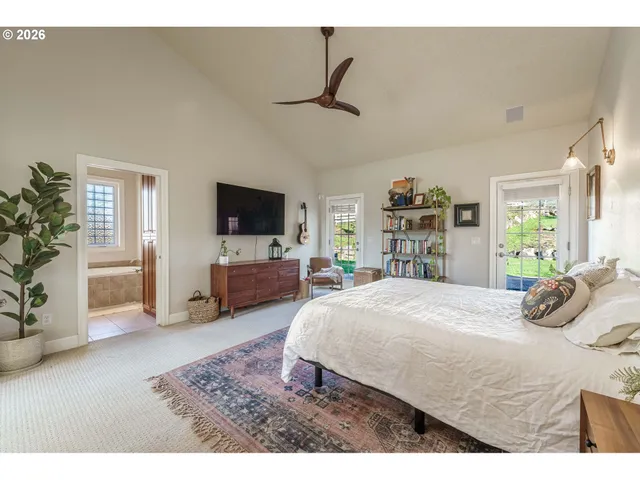 a living room with furniture a flat screen tv and a large window