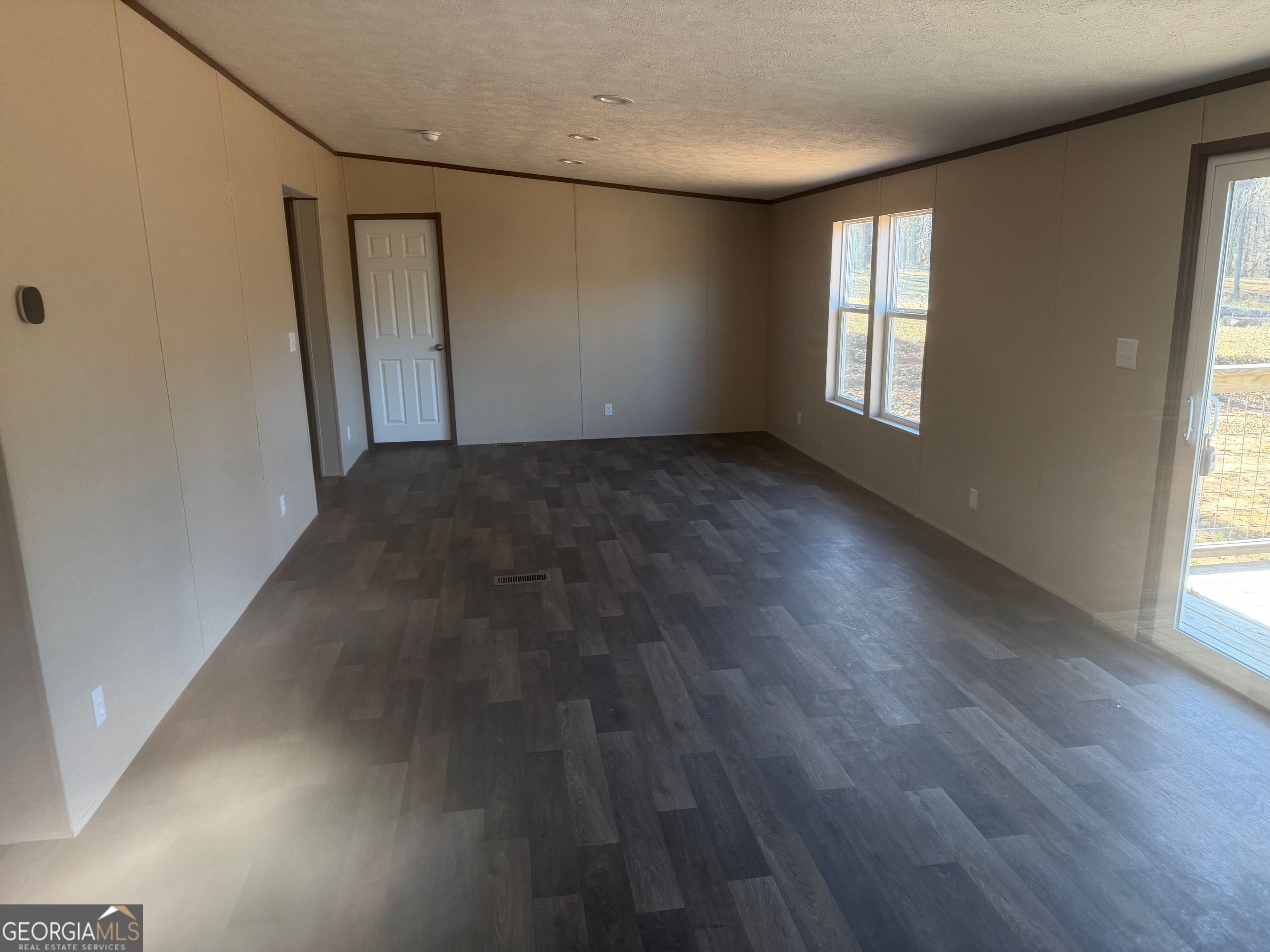 832 Stone Stewart Road Hull, GA 30646 - Photo 4 of 15 an empty room with wooden floor and windows