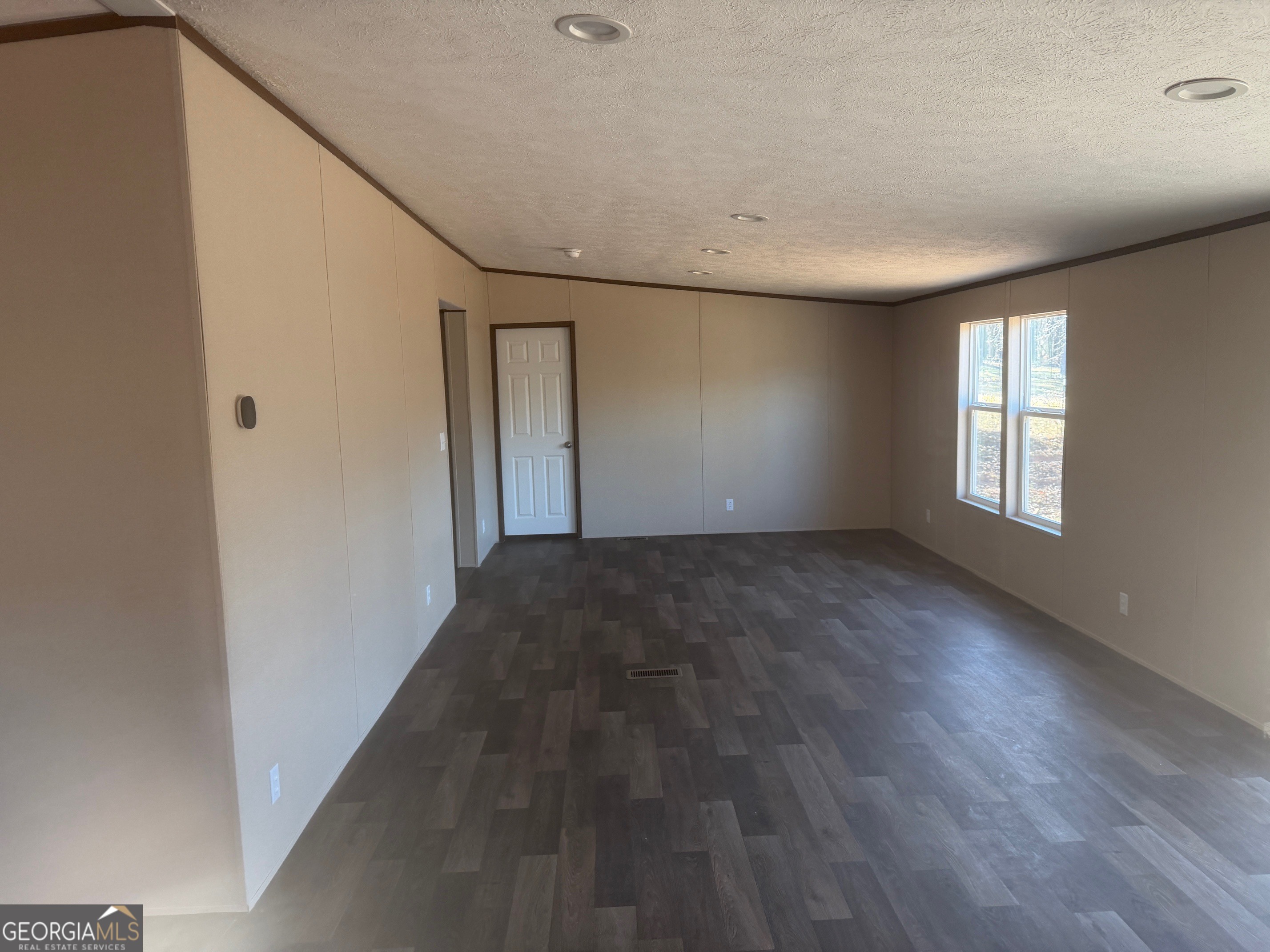 832 Stone Stewart Road Hull, GA 30646 - Photo 5 of 15 an empty room with wooden floor and windows
