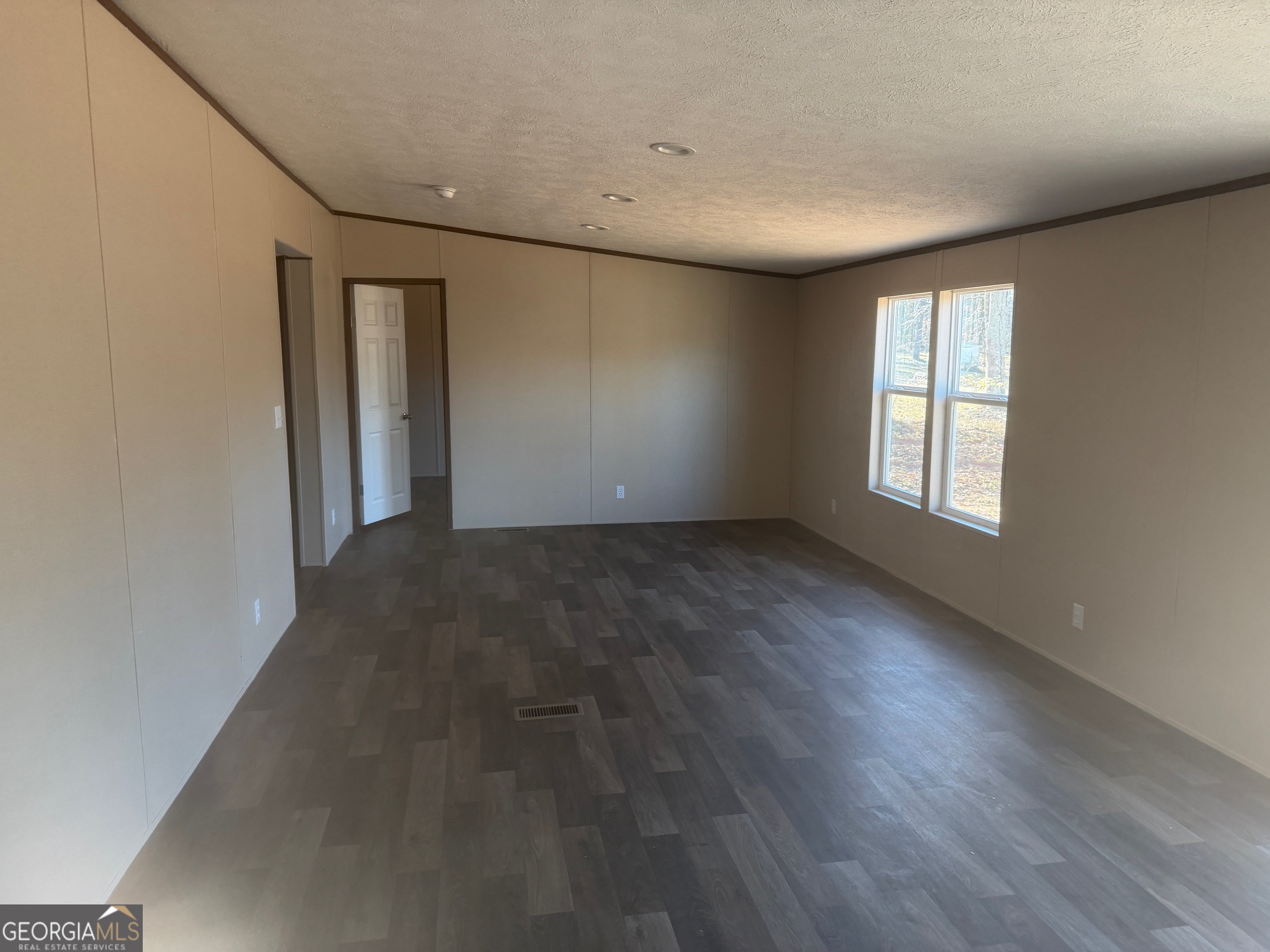 832 Stone Stewart Road Hull, GA 30646 - Photo 9 of 15 a view of an empty room with wooden floor and a window