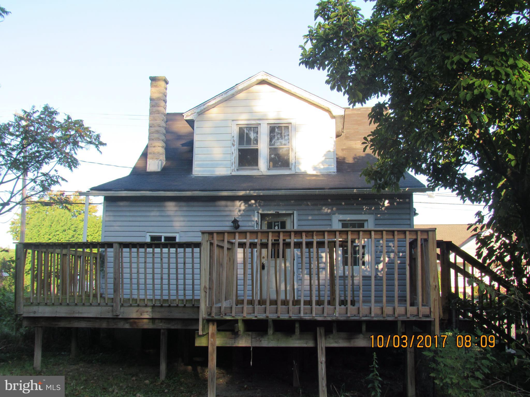 2907 Sparrows Point Road Baltimore, MD 21219 - Photo 3 of 24 a front view of a house with a yard