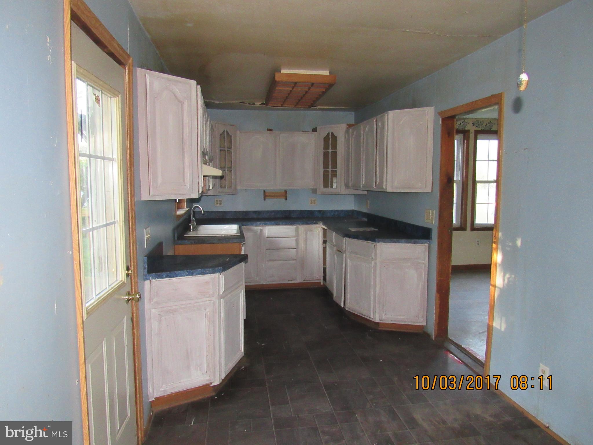 2907 Sparrows Point Road Baltimore, MD 21219 - Photo 8 of 24 a kitchen with stainless steel appliances granite countertop a sink a stove and a refrigerator